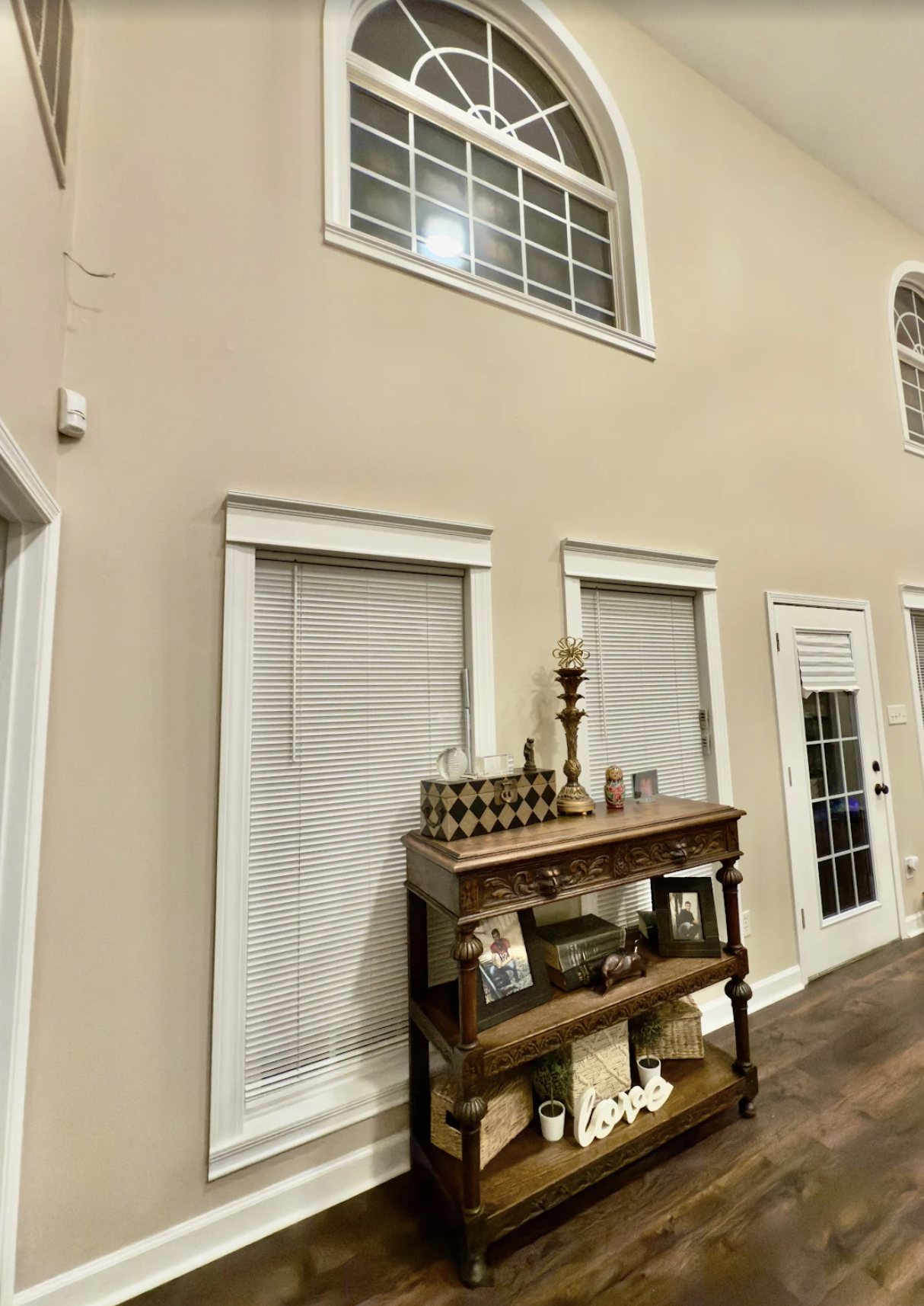 Two-story entry painted in warm cream with white trim, Little Rock