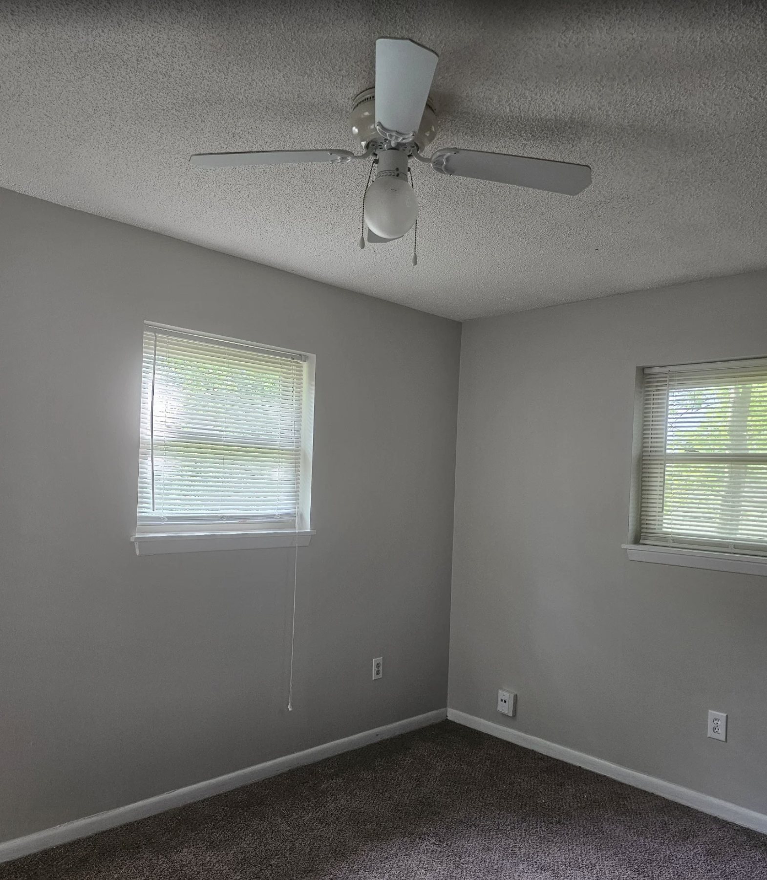 Bedroom repainted in soft grey with clean white trim lines