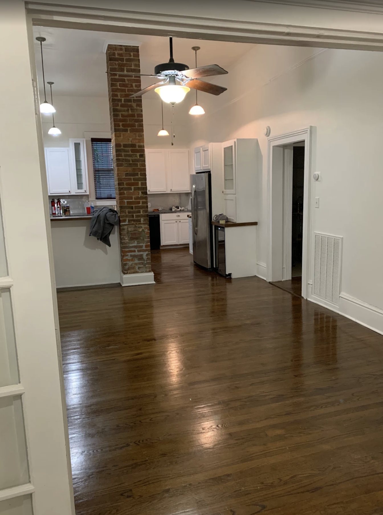 Open plan living and kitchen area with painted walls, ceiling and trim